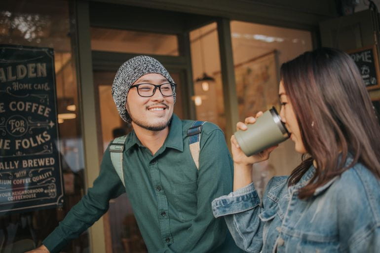 Girl drinking a hot drink and boy